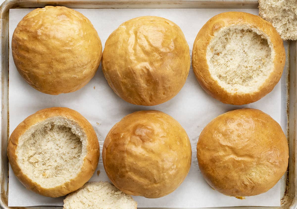 Bread Bowls on Sheet Pan with Two Cut Into and Hallowed Out.