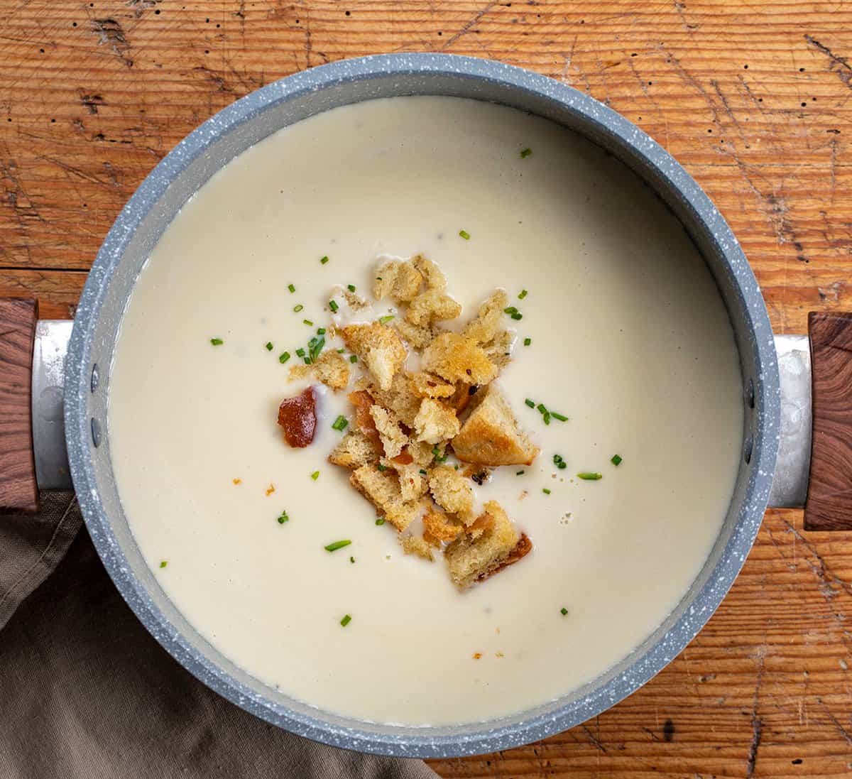 Overhead image of a Pot of 100 Clove Roasted Garlic Soup.