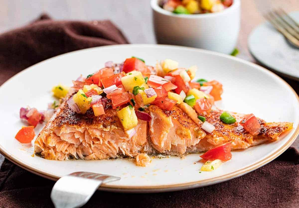 Cut Into Piece of Chili Lime Salmon with Pineapple Salsa Showing Flakey Salmon