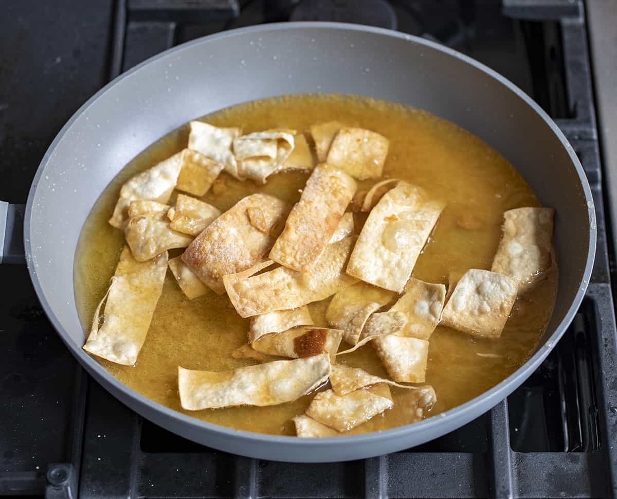 Frying wonton strips in a pan with oil. Wontons, Wonton Strips, Wonton Chips, Fried Wonton Chips, Oven Baked Wonton Chips, Crispy Wonton Chips, Fried Wontons, Asian Inspired Wonton Chips, recipes, i am homesteader, iamhomesteader