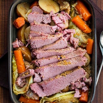 Overhead Image of Cooked Corned Beef Nestled Over Cabbage and Vegatables