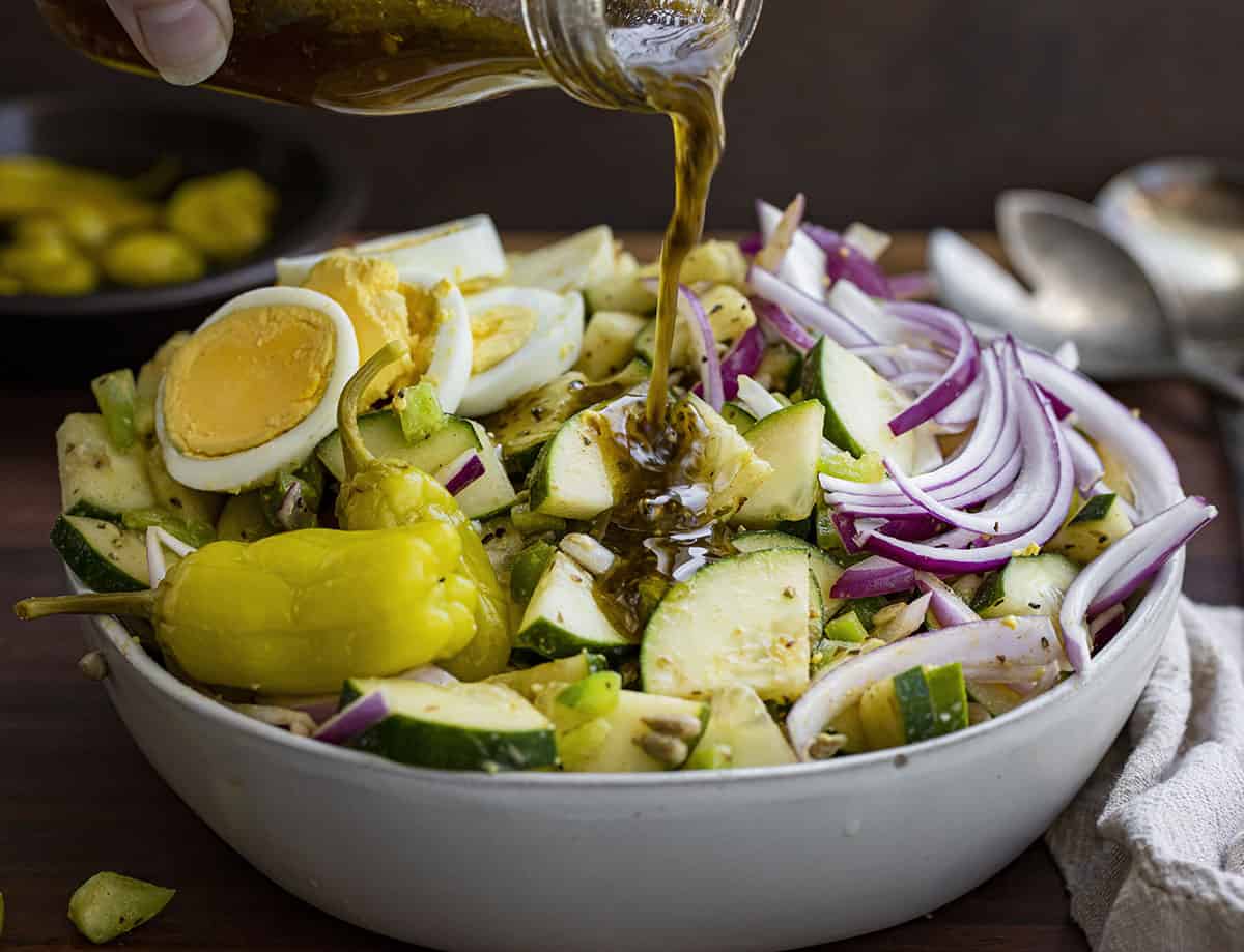 Pouring Italian Dressing Over a Hot Girl Salad