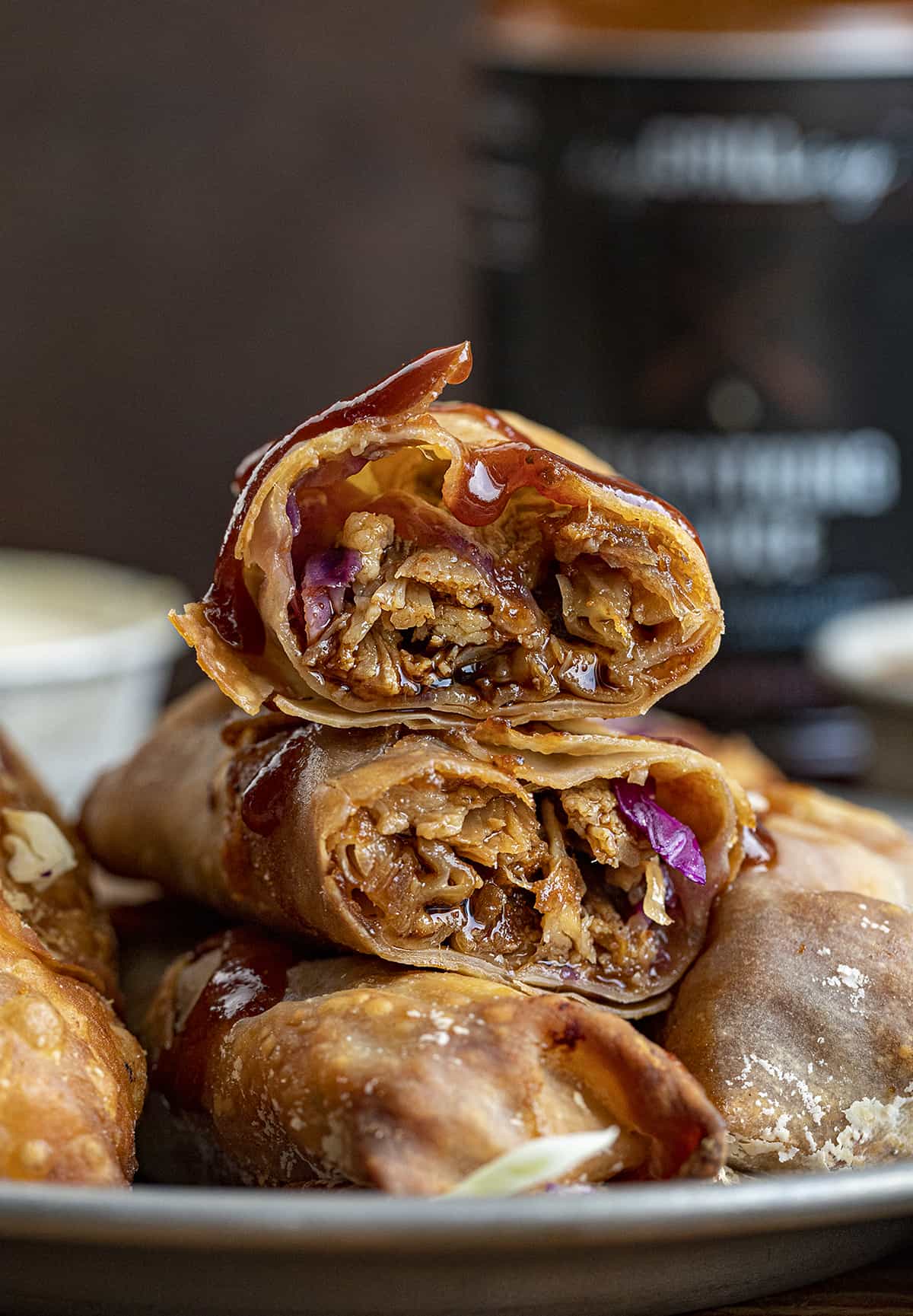 Air Fryer Pulled Pork Egg Rolls Cut Open to See the Inside and Stacked on a Plate