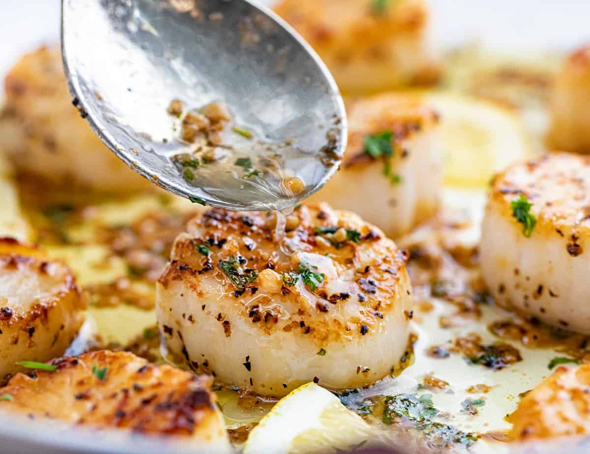 Spooning Garlic Butter Over Scallops.