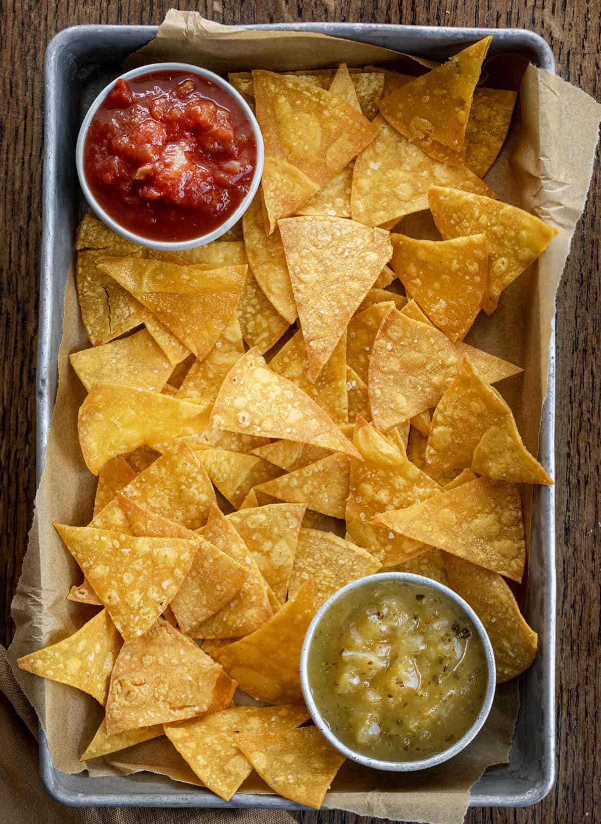 Pan of Tortilla Chips on a wooden table from overhead.