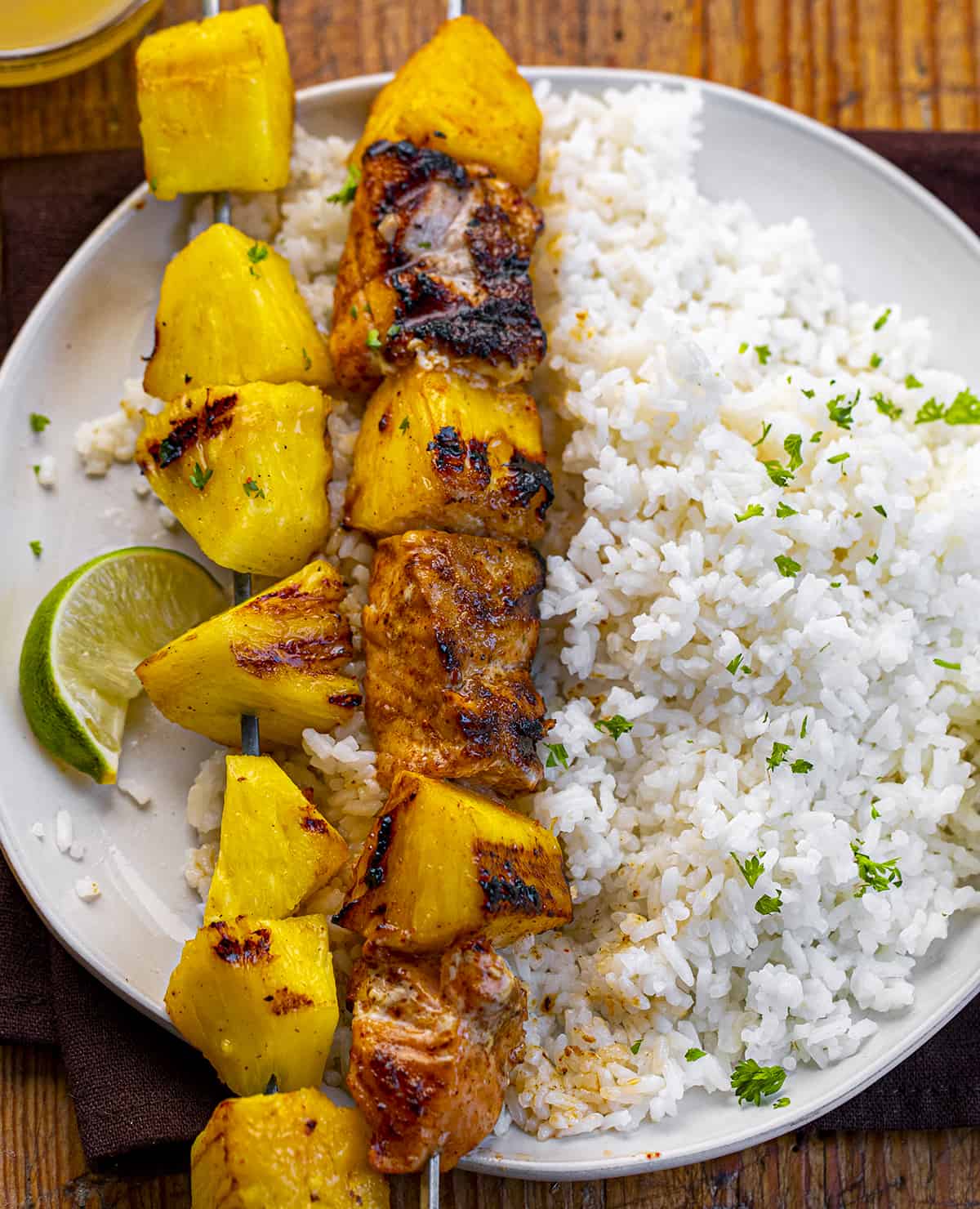 Plate with Pineapple Salmon Kebabs and Rice and a Lime. Dinner, Kebabs, Salmon Kebabs, Pineapple Kebabs, Grilling, Air Fryer Kebabs, Oven Kebabs, Seafood Kebabs, Summer Kebabs, How to Make Kebobs, recipes, i am homesteader, iamhomesteader
