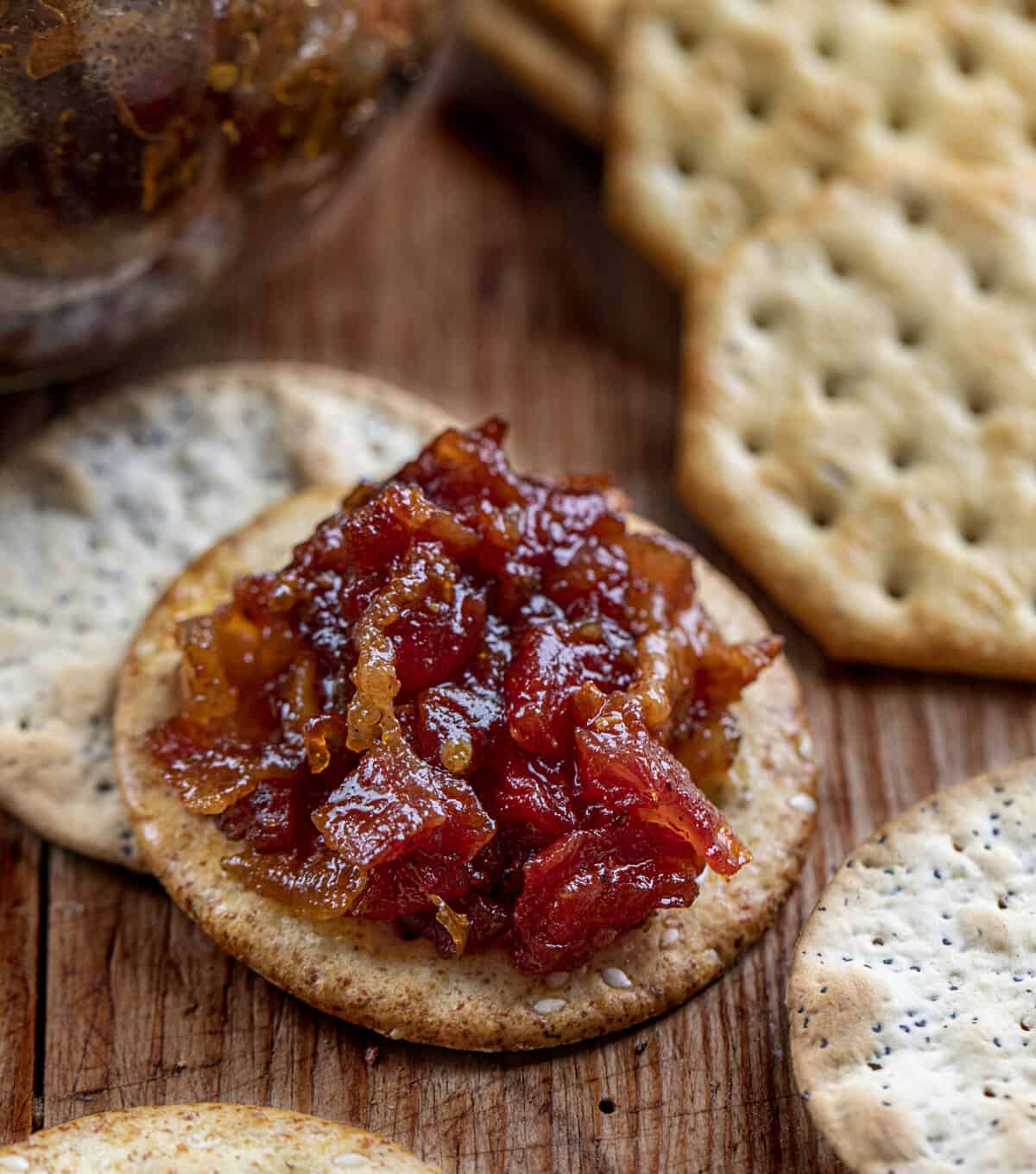 Tomato Baon Jam on a Cracker Next to a Jar. Jam, Bacon Jam, Tomato Bacon Jam, Bacon Marmalade, Bacon Jam Recipe, Appetizer, Super Bowl Appetizer, Game Day Food, Best Appetizers, Best Burger Toppings, i am homesteader, iamhomesteader