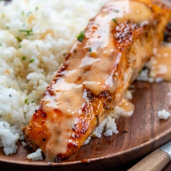 Piece of Bang Bang Salmon with Rice on a Wooden Plate. Dinner, Supper, Salmon, Salmon Recipes, Sweet Salmon, Bang Bang Sauce, Easy Dinner Ideas, Salmon Recipe Ideas, Salmon Fillets, Skin On Salmon, i am homesteader, iamhomesteader