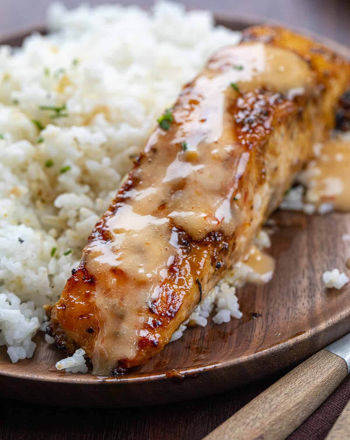 Piece of Bang Bang Salmon with Rice on a Wooden Plate. Dinner, Supper, Salmon, Salmon Recipes, Sweet Salmon, Bang Bang Sauce, Easy Dinner Ideas, Salmon Recipe Ideas, Salmon Fillets, Skin On Salmon, i am homesteader, iamhomesteader