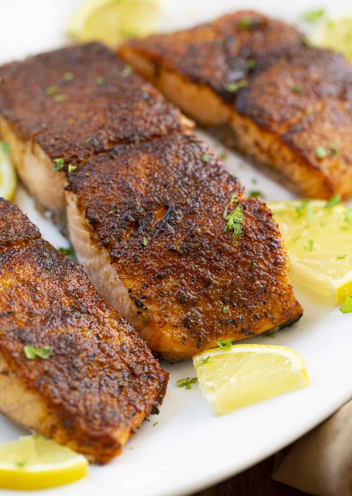 Close up a a Piece of Blackened Salmon on a Plate. Dinner, Supper, Salmon Recipes, Blackened Salmon, Air Fryer Recipes, How to Make Salmon in the Air Fryer, Baked Salmon, Baked Blackened Salmon, i am homesteader, iamhomesteader