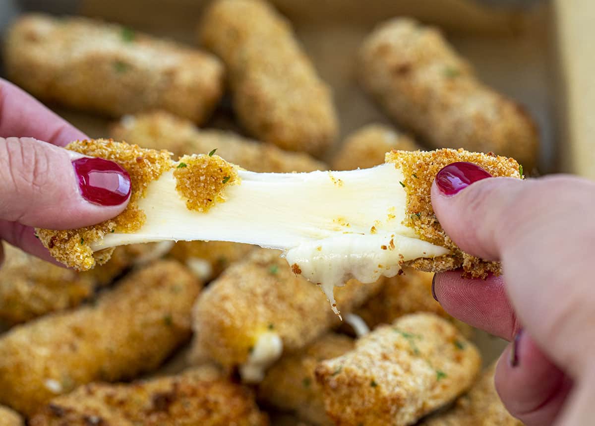 Hot Mozzarella Stick Being Pulled Apart. Appetizers, Cheese Sticks, How to Make Cheese Sticks, How to Make Mozzarella Sticks, Superbowl Food, Football Appetizers, Easy Appetizers, Air Fryer Appetizers, Hot Appetizers, i am homesteader, iamhomesteader