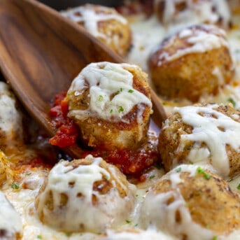 Spoon Picking up a Chicken Meatball Covered in Cheese. Dinner, Supper, Meatballs, Chicken Meatballs, Chicken Parmesan Meatballs, Chicken Meatball Recipes, Chicken, Chicken Recipes, Christmas Dinner, i am homesteader, iamhomesteader