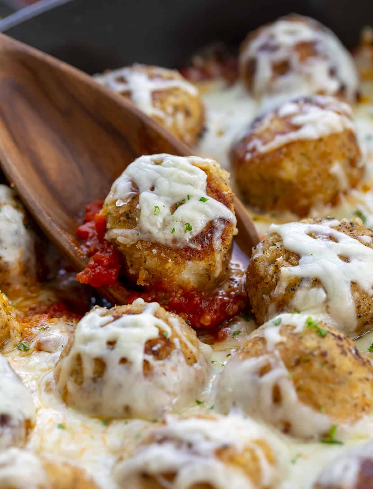 Spoon Picking up a Chicken Meatball Covered in Cheese. Dinner, Supper, Meatballs, Chicken Meatballs, Chicken Parmesan Meatballs, Chicken Meatball Recipes, Chicken, Chicken Recipes, Christmas Dinner, i am homesteader, iamhomesteader