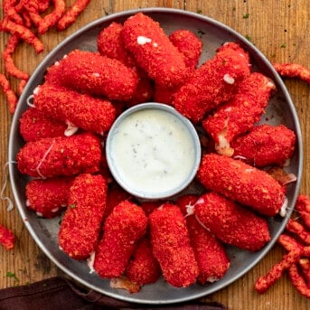 Hot Flamin Hot Cheeto Mozzarella Sticks on a Plate with Ranch Dressing. Appetizer, Cheese Sticks, Flamin Hot Cheese Sticks, SuperBowl Food, Football Snacks, Cheese Sticks Recipes, Football Appetizer Ideas, Party Appetizer Ideas, i am homesteader, iamhomesteader