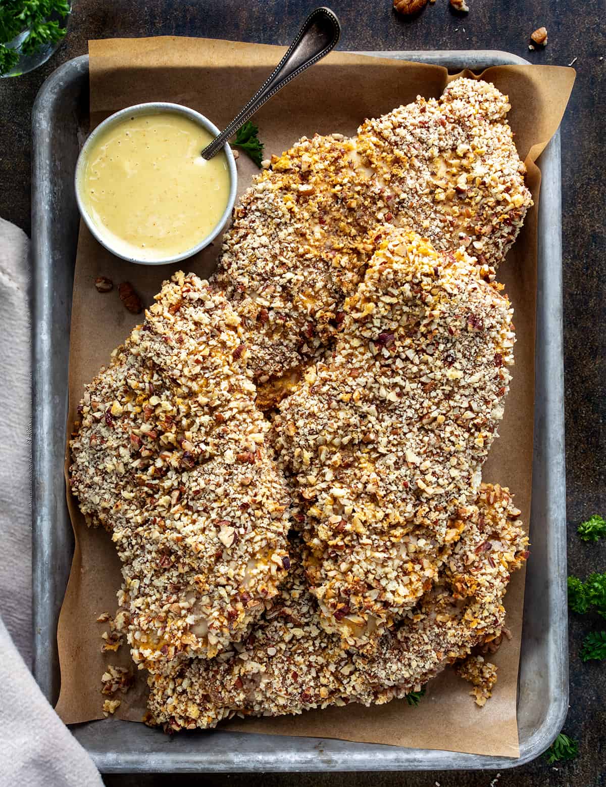 Pecan Crusted Chicken in a Platter with Sauce from Overhead.