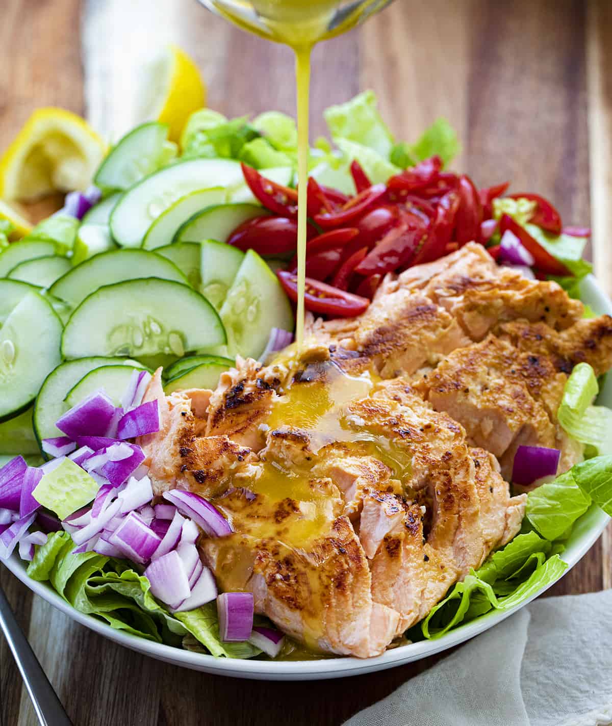 Pouring Dressing Over Salmon Salad. Salad, Summer Salad, Salmon Salad, Hot Salmon Salad, Cold Salmon Salad, Green Salad with Salmon, Dressing for Salmon Salad, Meal Prep Salad, Healthy Salad, Easy Delicious Salad, i am homesteader, iamhomesteader