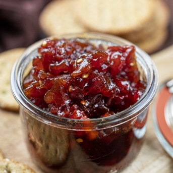 Jar of Spicy Tomato Jam on a Cutting Board. Appetizer, Burger Topping Idea, Tomato Jam, How to Make Tomato Jam, Spicy Jam, Homemade Tomato Jam, How to Can Tomato Jam, Cracker Spreads, Super Bowl Food, Christmas Appetizers, Thanksgiving Appetizers, i am homesteader, iamhomesteader