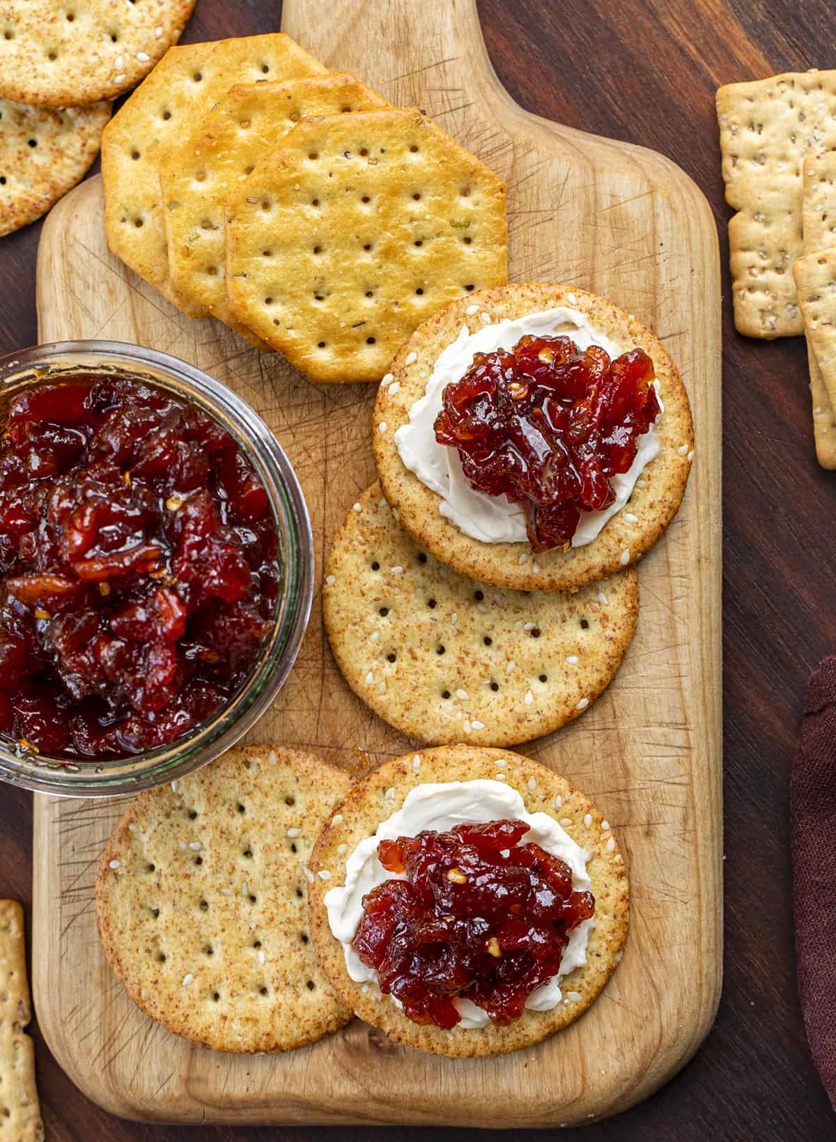 Overhead Image of Crackers with Spicy Tomato Jam on Crackers and the Jar of Jam. Appetizer, Burger Topping Idea, Tomato Jam, How to Make Tomato Jam, Spicy Jam, Homemade Tomato Jam, How to Can Tomato Jam, Cracker Spreads, Super Bowl Food, Christmas Appetizers, Thanksgiving Appetizers, i am homesteader, iamhomesteader