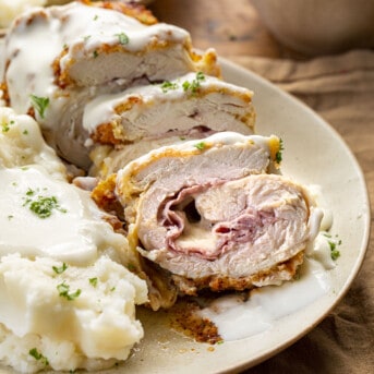 Sliced Chicken Cordon Bleu on a Plate with Mashed Potatoes and Swiss Cheese Sauce. Dinner, Supper, Air Fryer Recipes, Chicken, Chicken Recipes, Chicken Cordon Bleu, Air Fryer Chicken Cordon Bleu, Swiss Cheese Sauce, How to Make Cheesy Sauce with Swiss Cheese, i am homesteader, iamhomesteader