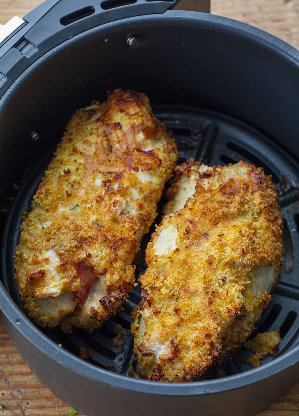Two Chicken Cordon Bleu's in a Air Fryer Basket. Dinner, Supper, Air Fryer Recipes, Chicken, Chicken Recipes, Chicken Cordon Bleu, Air Fryer Chicken Cordon Bleu, Swiss Cheese Sauce, How to Make Cheesy Sauce with Swiss Cheese, i am homesteader, iamhomesteader