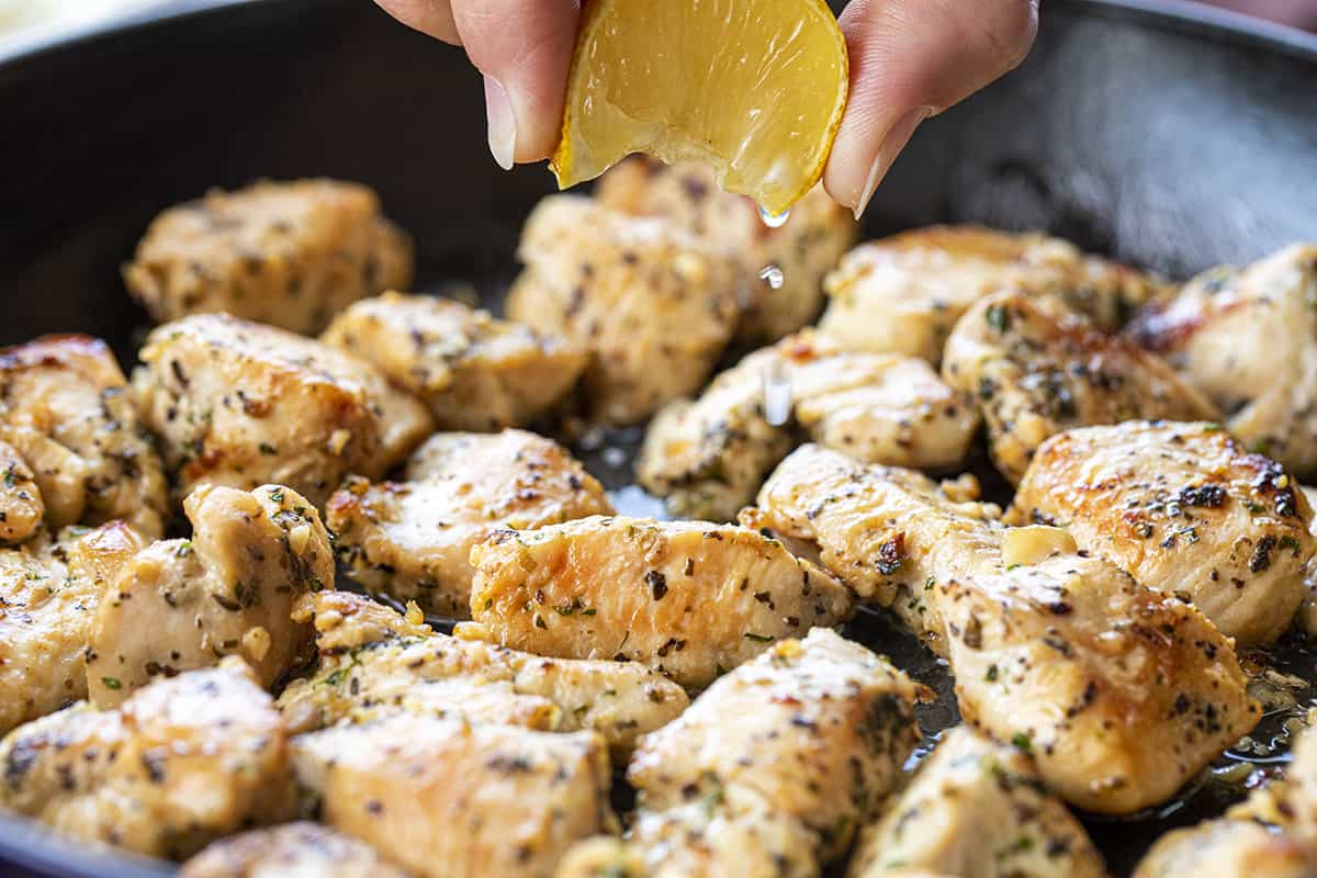 Squeezing Lemon over Garlic Chicken Bites in Pan. Dinner, Supper, Chicken Bite Recipes, Chicken Recipes, How to Make Chicken Bites, Easy Chicken Bites, Quick Chicken Dinners, Lemon Chicken, Garlic Chicken, i am homesteader, iamhomesteader