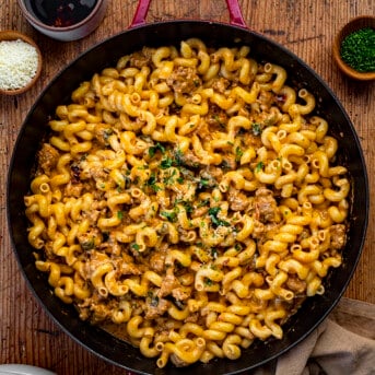 Overhead image of a Pan of Spicy Sausage Pasta on a Cutting Board before Serving. Dinner, Supper, Spicy Sausage Recipes, Dinner Recipes, Best Pasta Recipes, Pasta, Whats for Dinner, recipes, i am homesteader, iamhomesteader, viral tiktok