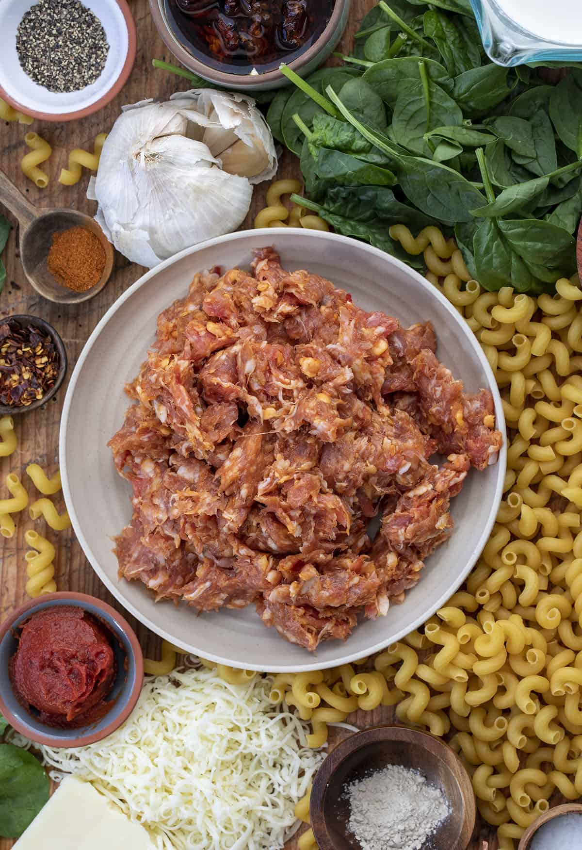 Raw Ingredients on a Cutting Board that Make up Spicy Sausage Cavatappi. Dinner, Supper, Spicy Sausage Recipes, Dinner Recipes, Best Pasta Recipes, Pasta, Whats for Dinner, recipes, i am homesteader, iamhomesteader, viral tiktok