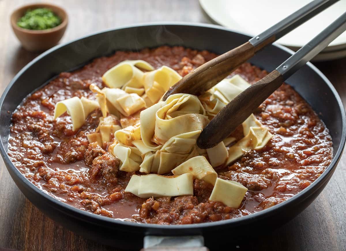 Stirring Noodles into Bolognese Sauce. Dinner, Supper, Dinner Idea, Italian Recipes, How to Make Bolognese, i am homesteader, iamhomesteader