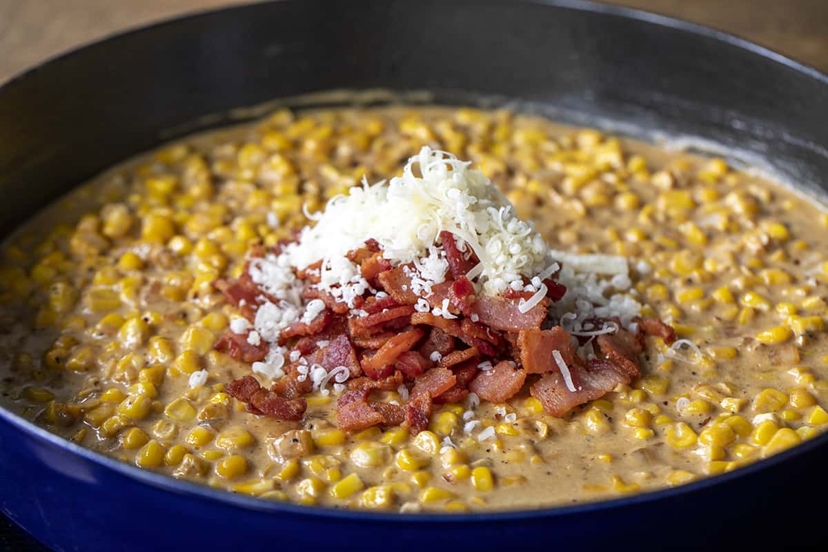 Creamed Corn in a Pan with Bacon and Parmesan Being Added on Top. Dinner, Supper, Chicken, Chicken Recipes, Chicken with Creamed Corn, Garlic Butter Creamed Corn Chicken, Dinner Ideas, homestead recipes, recipes, i am homesteader, iamhomesteader