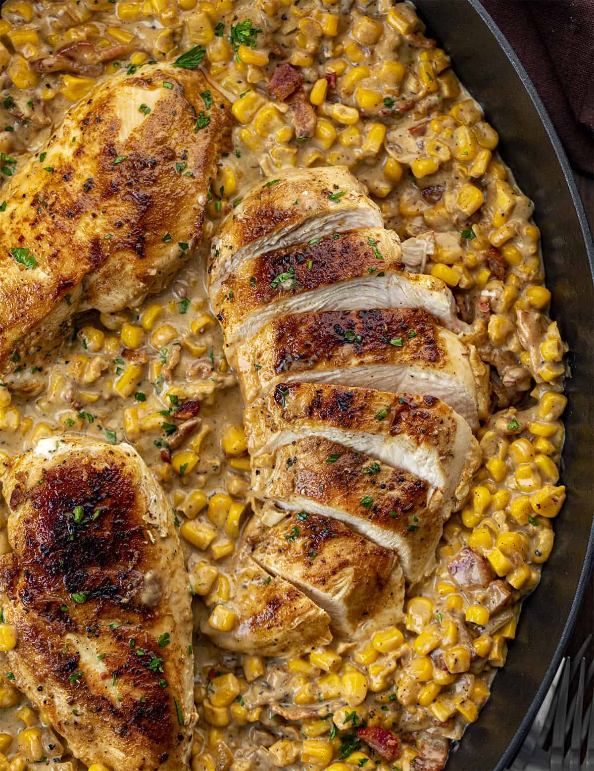 Pan of Chicken and Bacon Creamed Corn with Chicken Sliced from OVerhead. Dinner, Supper, Chicken, Chicken Recipes, Chicken with Creamed Corn, Garlic Butter Creamed Corn Chicken, Dinner Ideas, homestead recipes, recipes, i am homesteader, iamhomesteader