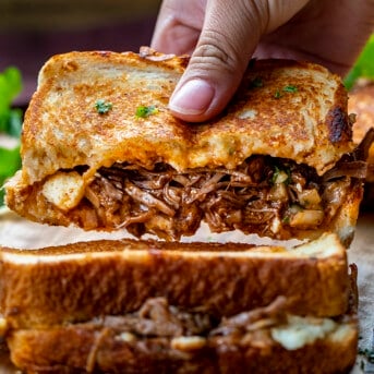 Hand Picking up a Birria Grilled Cheese Recipe. Dinner, Supper. Grilled Cheese, Best Grilled Cheese, Birria Grilled Cheese Sandwich, Shredded Beef Grilled Cheese, Superbowl Food, Game Day Food, Football Recipes, i am homesteader, iamhomesteader