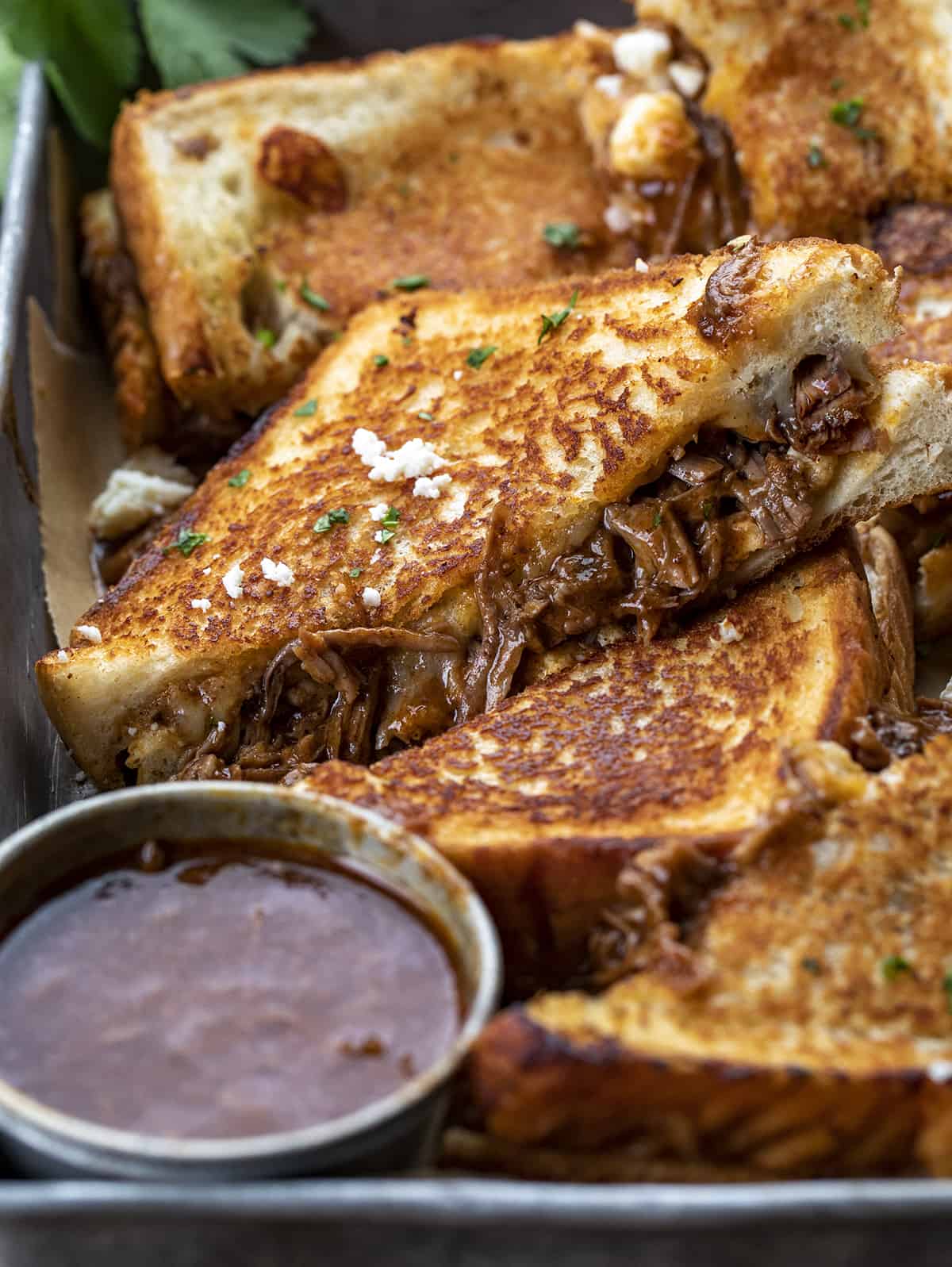 Birria Grilled Cheese Sandwiches in a Dish Next to Sauce. Dinner, Supper. Grilled Cheese, Best Grilled Cheese, Birria Grilled Cheese Sandwich, Shredded Beef Grilled Cheese, Superbowl Food, Game Day Food, Football Recipes, i am homesteader, iamhomesteader