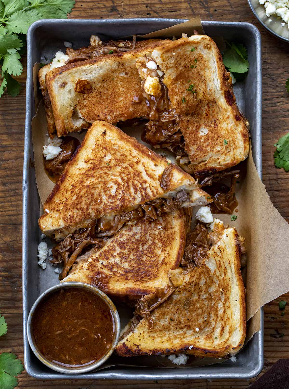 Halved Shredded Beef Birria Grilled Cheese Sandwiches in a Pan from OVerhead. Dinner, Supper. Grilled Cheese, Best Grilled Cheese, Birria Grilled Cheese Sandwich, Shredded Beef Grilled Cheese, Superbowl Food, Game Day Food, Football Recipes, i am homesteader, iamhomesteader