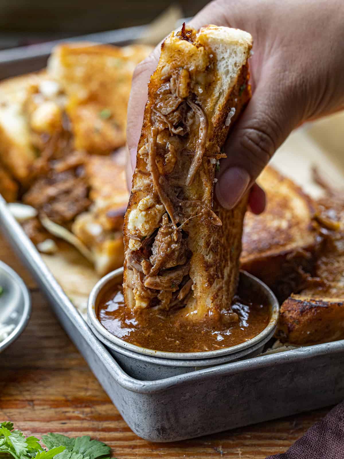 Hand Dipping a Birria Grilled Cheese Into Sauce. Dinner, Supper. Grilled Cheese, Best Grilled Cheese, Birria Grilled Cheese Sandwich, Shredded Beef Grilled Cheese, Superbowl Food, Game Day Food, Football Recipes, i am homesteader, iamhomesteader