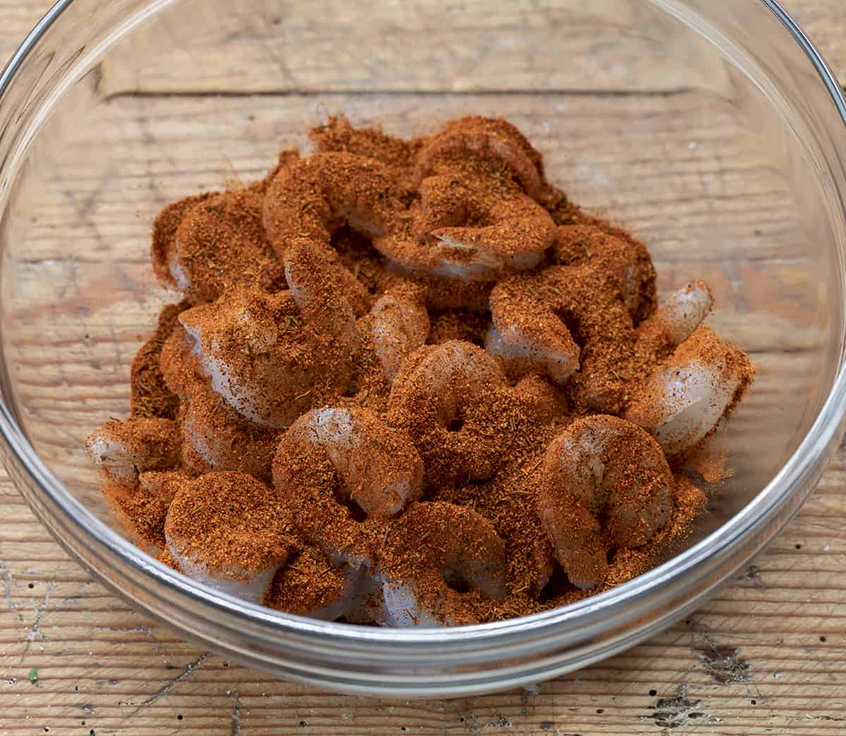 Raw Shrimp Coated in Blackened Seasoning in a Bowl.