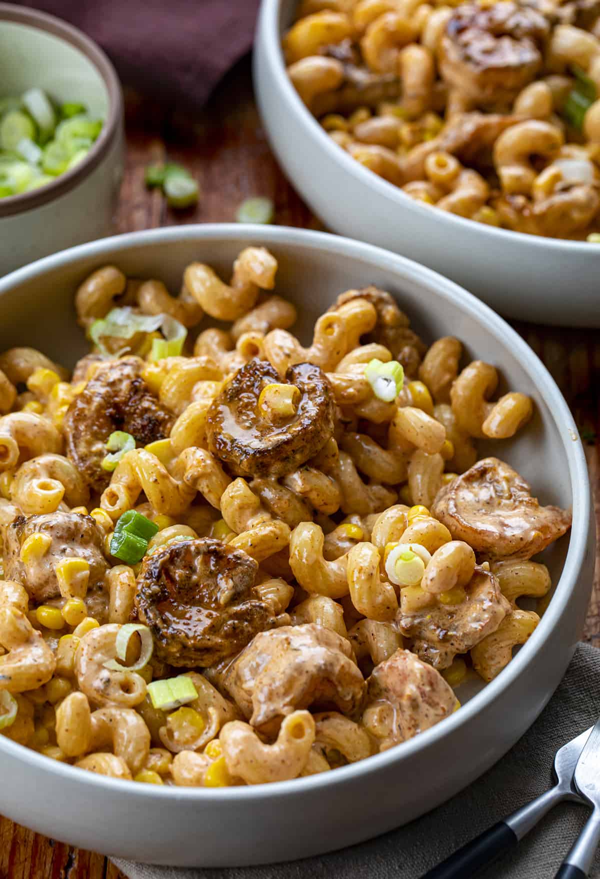 Bowls of Blackened Shrimp Cavatappi Sprinkled with Green Onion.