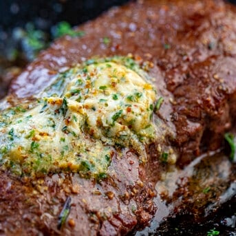 Cowboy Butter Melted on a Steak in a Skillet.