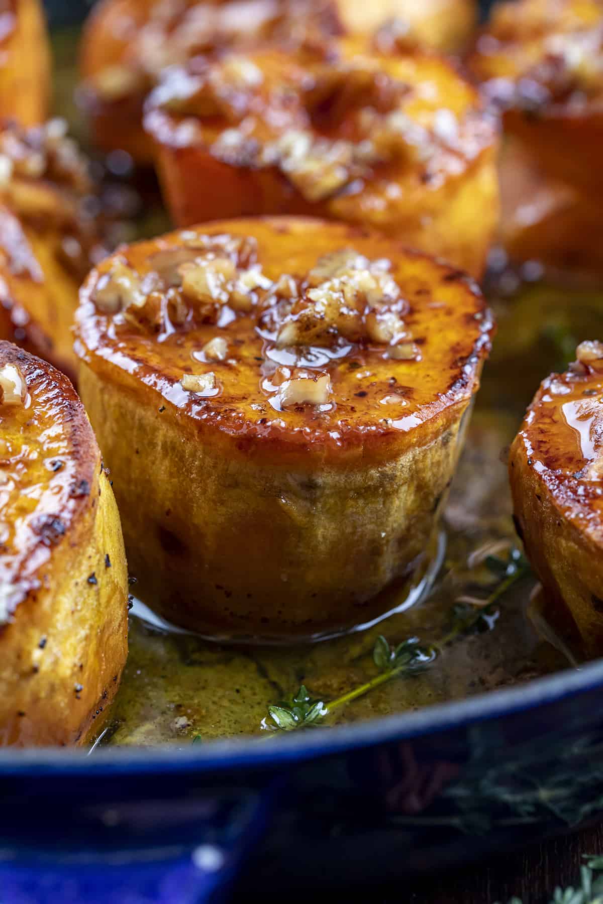 Fondant Sweet Potatoes that are cooked in a Skillet with Bourbon Pecan Glaze On Top.