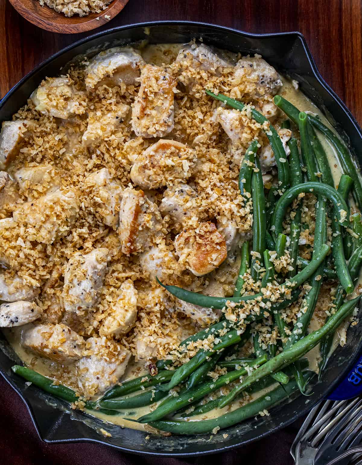 Crispy Honey Mustard Chicken Bites with Green Beans in a Skillet on a Cutting Board.