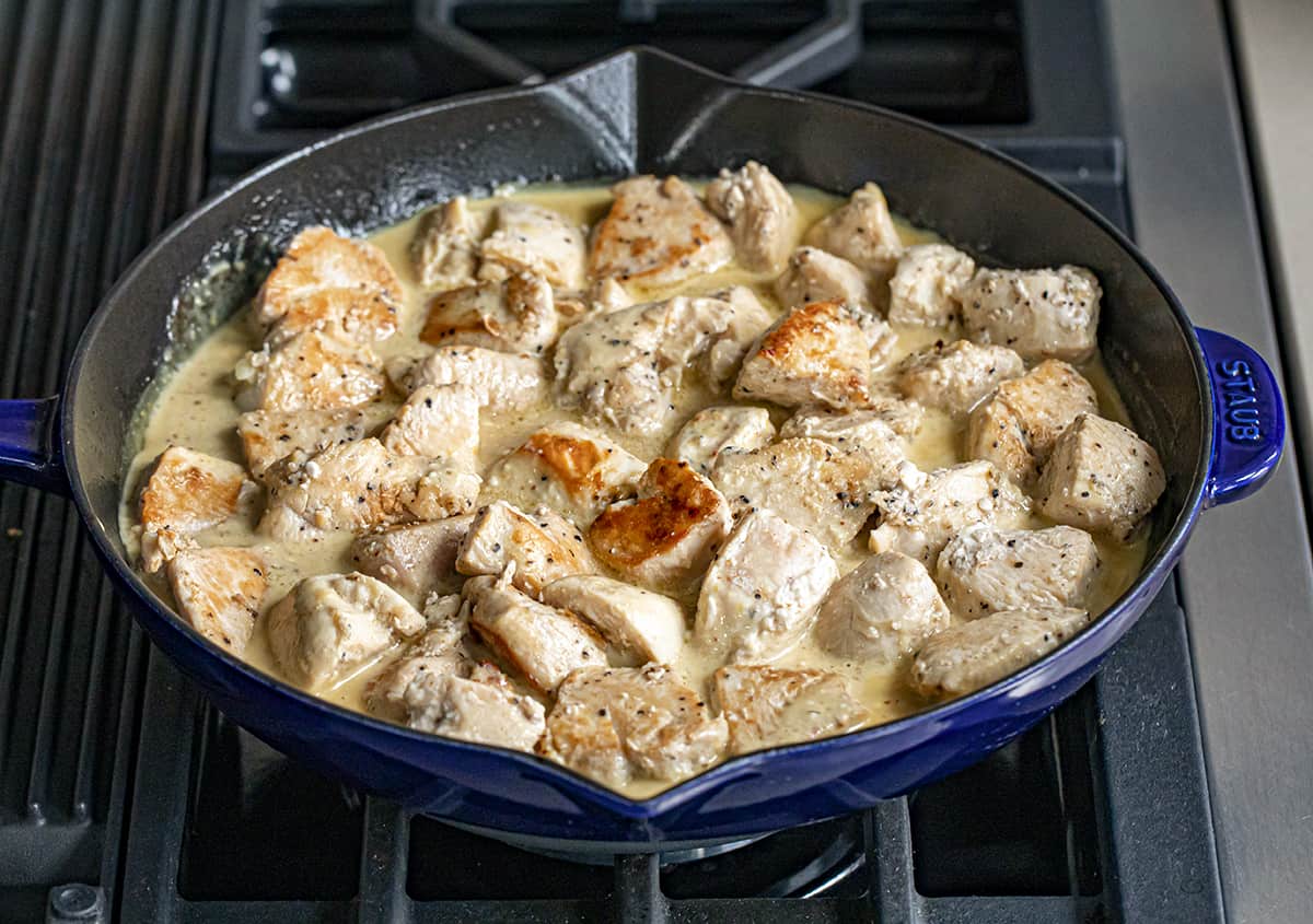 Chicken Bites in a Skillet on Stove Top in Honey Mustard Sauce.