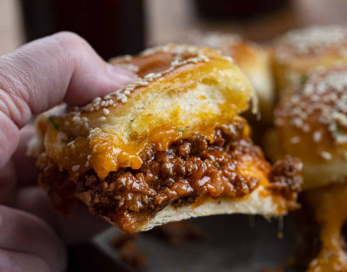 Hand Picking up a Sloppy Joe Slider with Cheese.