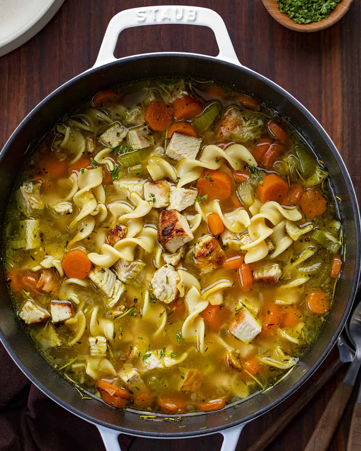Pot of Turkey Noodle Soup on a Cutting Board from Overhead.
