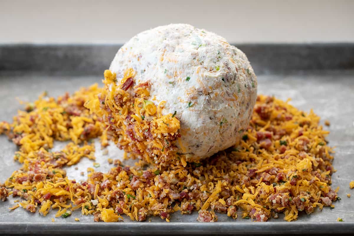 Rolling a Cheese Ball in Exterior Toppings.