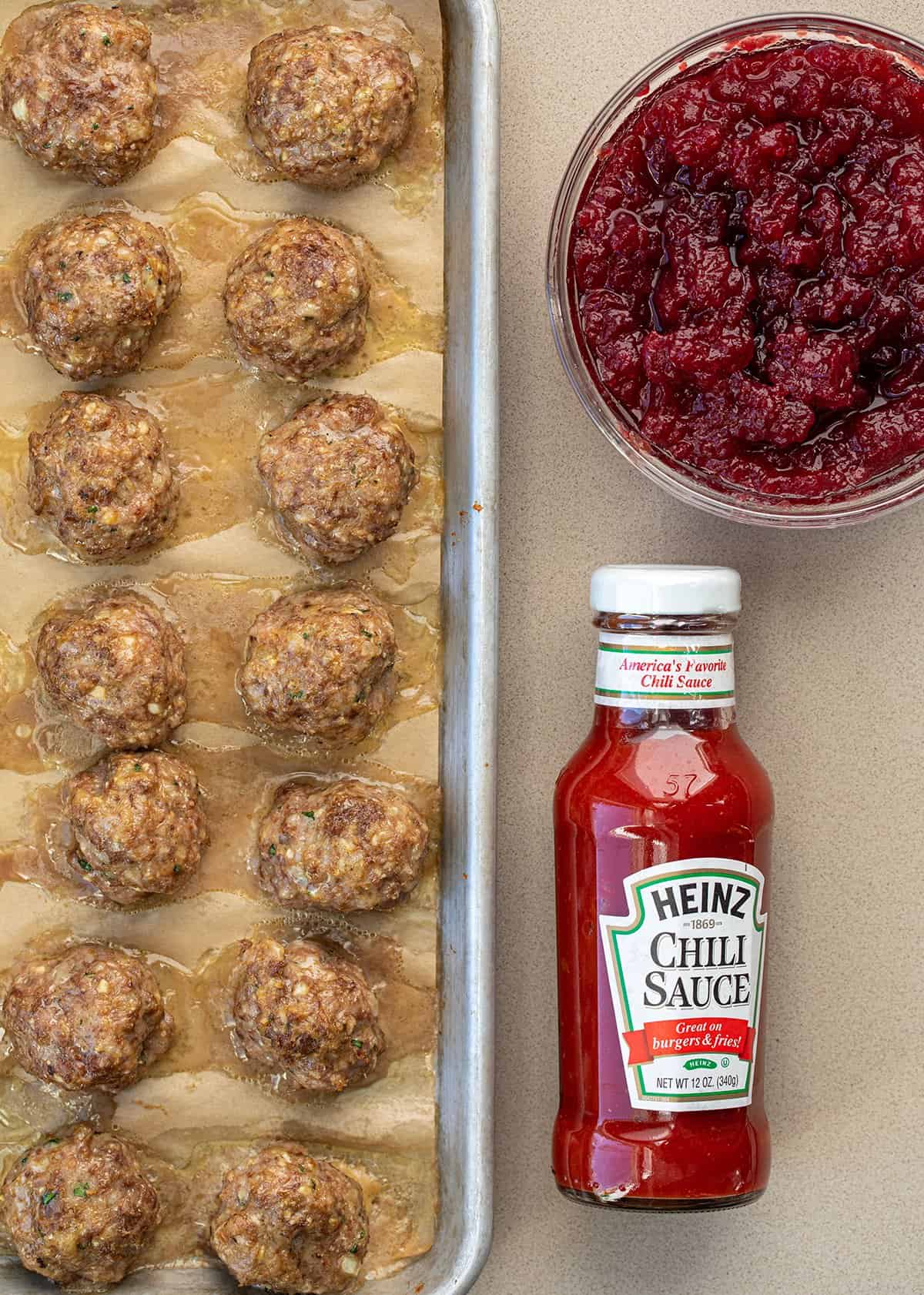 Meaatballs, Chili Sauce, and Cranberries on a Counter before assembling Slow Cooker Cranberry Meatballs.