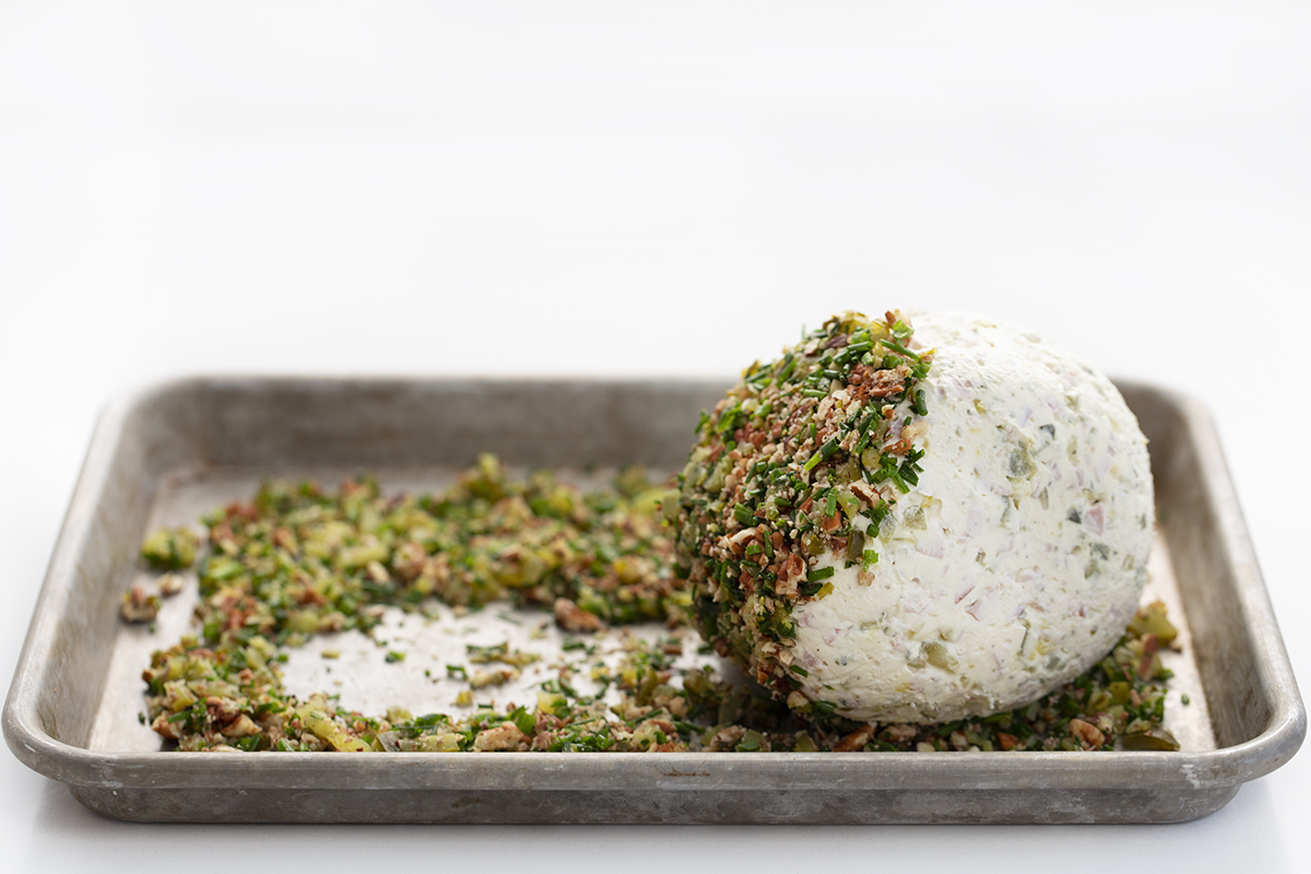 How to Roll Cheese Ball in Toppings to Make a Dill Pickle Cheese Ball.