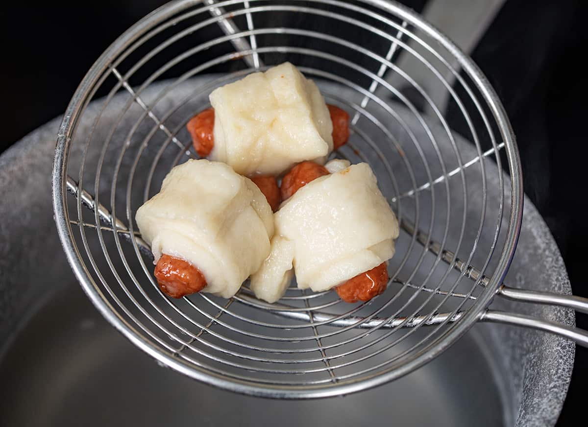 Boiling Pigs in a Blanket Before Baking So you Can me them Pretzel.