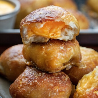 Stack of Cheesy Pretzel Bombs on a Cutting Board.