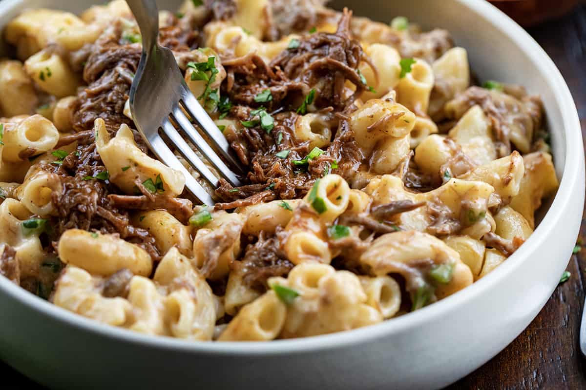 Fork Taking a Bite of Shredded Beef Macaroni and Cheese.