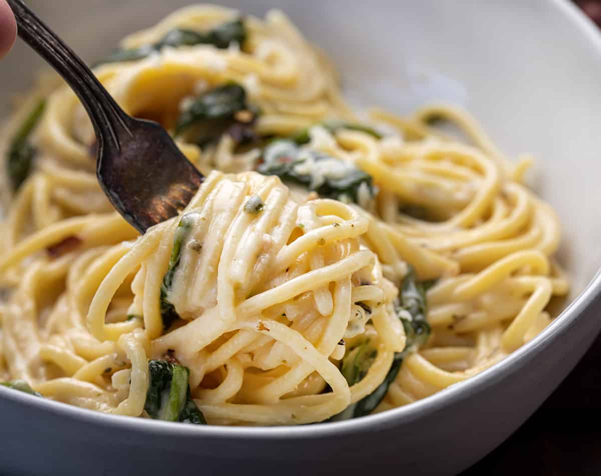 Fork with Asiago Pasta swirled on it showing how creamy it is.