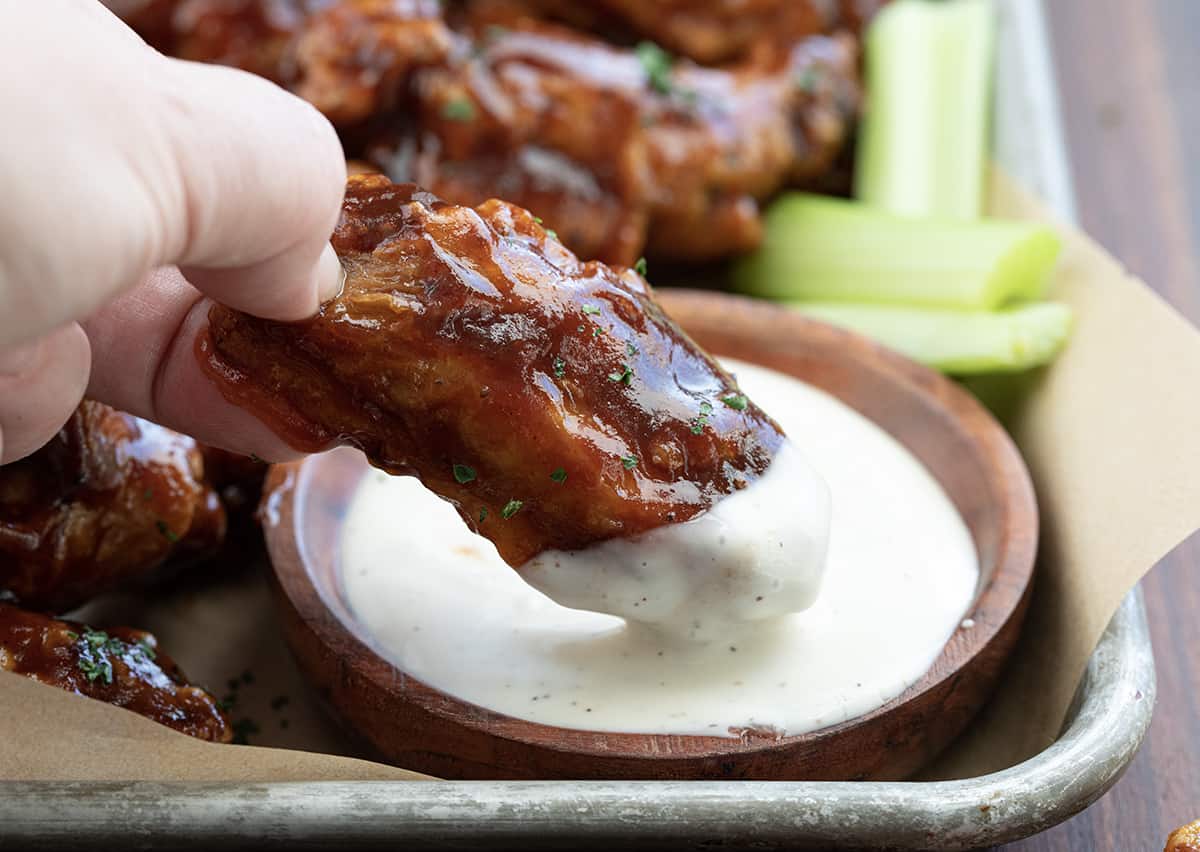 Hand Dipping BBQ Wing into Ranch Dressing.